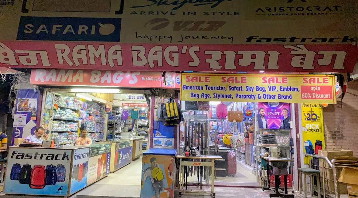 An earlier Rama Bags storefront with bags displayed around the entrance.