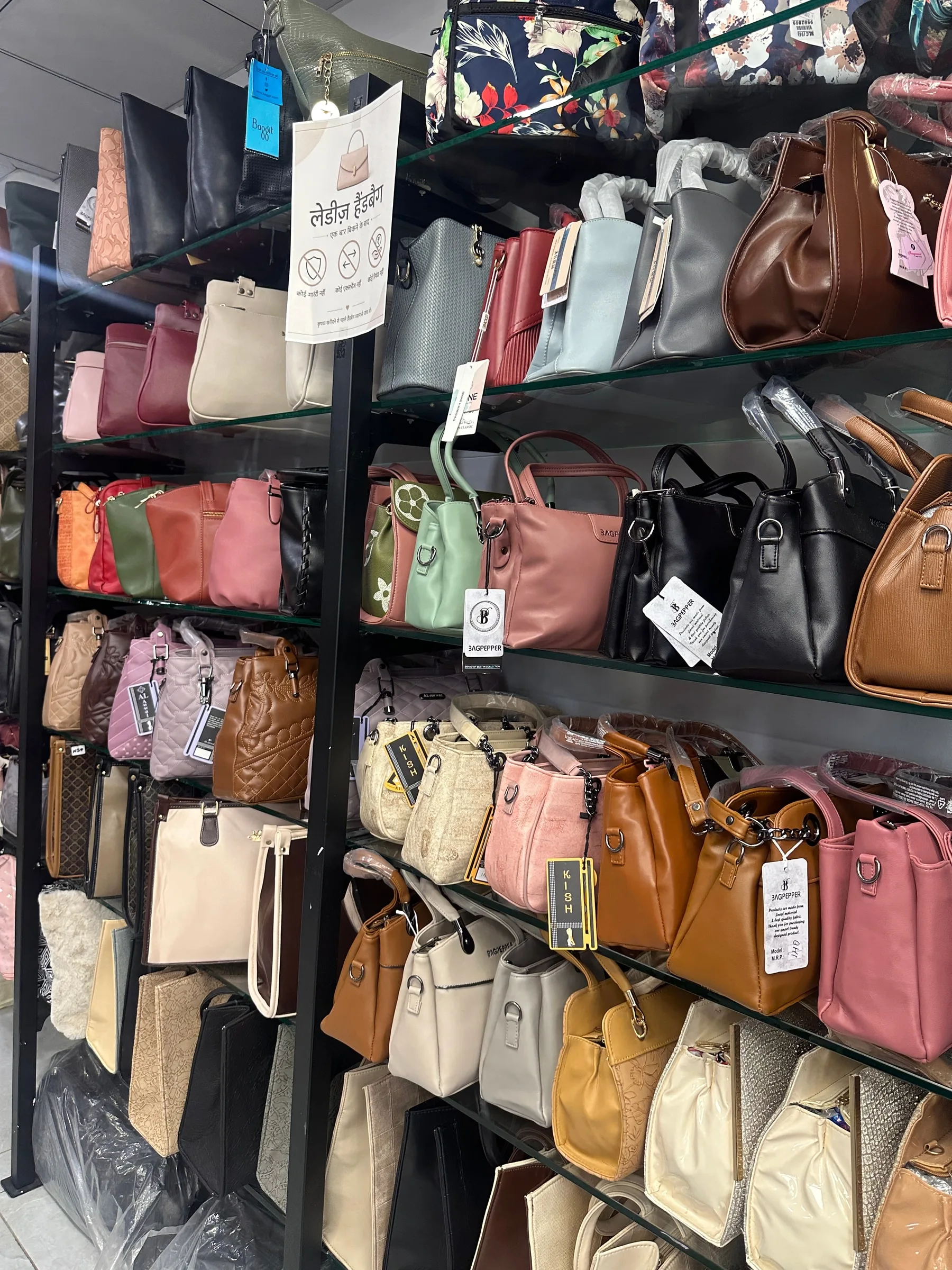 Handbags in many shapes and colors filling the store shelves.